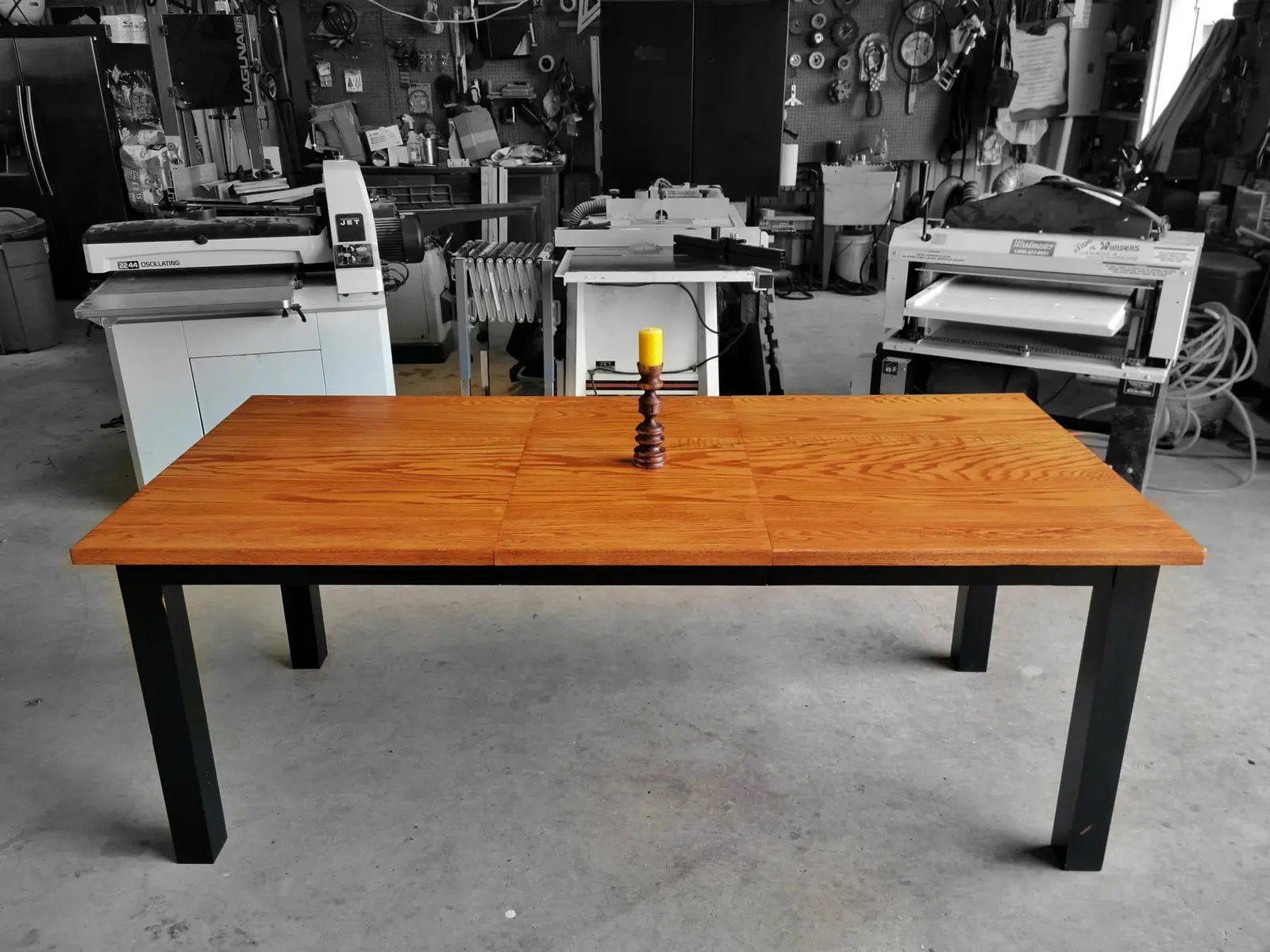 A hardwood top on a slim black metal base, the profile a mid century room wants