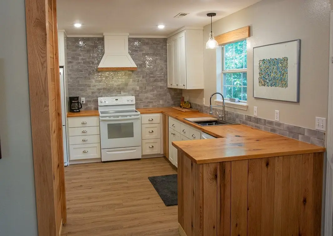 A hardwood countertop fitted into a remodeled kitchen