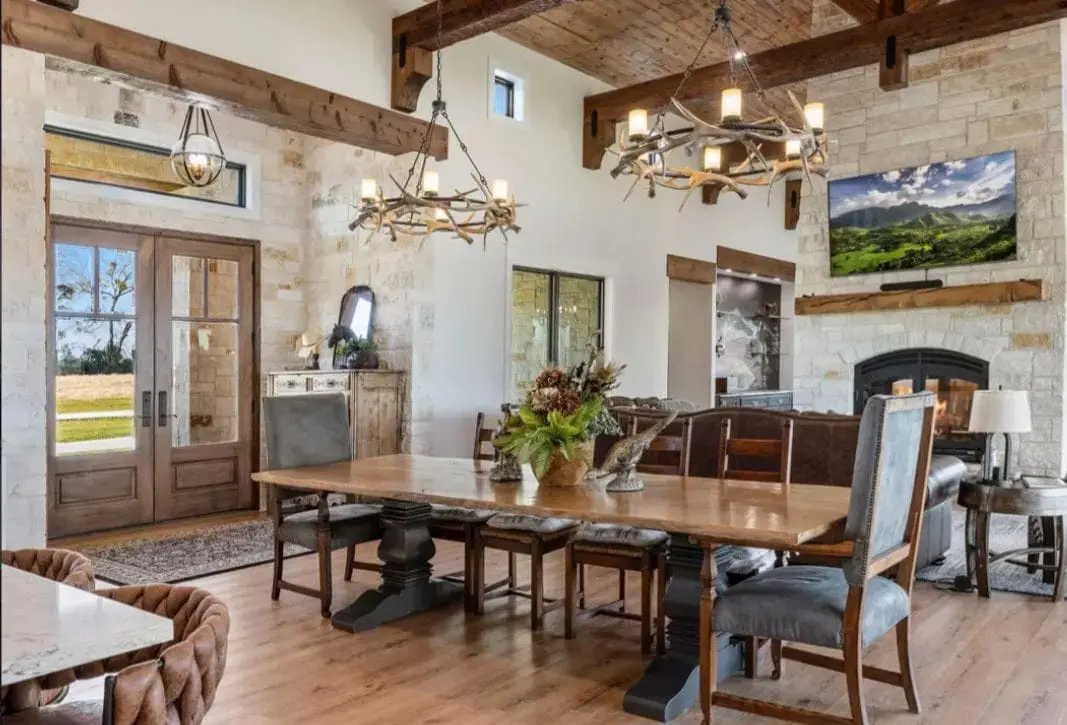 A long hardwood dining table in a family's great room, built in Wolfe City