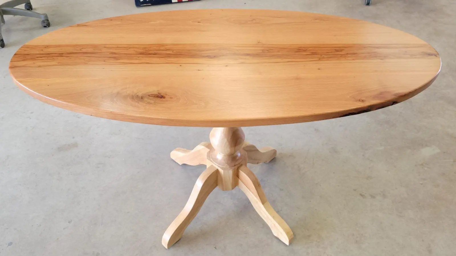 A round pedestal hardwood table of the kind Plano breakfast areas take